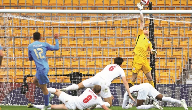 England goalkeeper Aaron Ramsdale (right) saves a shot off Italyu2019s Matteo Pessina (left) during the UEFA Nations League Group C match at the Molineux Stadium in Wolverhampton, Britain, on Saturday night. (Reuters)