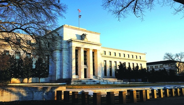 The Federal Reserve building is seen in Washington. Slammed by critics for not anticipating the fastest price gains in four decades and then for being too slow to respond to it, chairman Jerome Powell and colleagues on Wednesday intensified their effort to cool prices by lifting the target range for the federal funds rate to 1.5% to 1.75%.