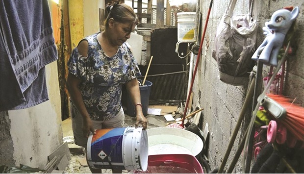 SPOTLIGHT: Maria Ju?rez fills a container with water at her house in Monterrey, Nuevo Leon, Mexico. (Thomson Reuters Foundation/Diana Baptista)