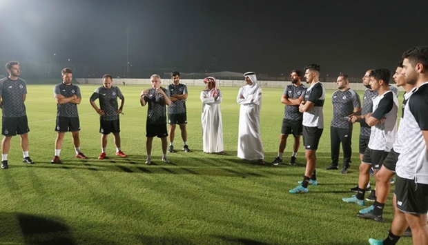 Juan Manuel Lillo talks to Al Sadd's players during a training session on Monday.