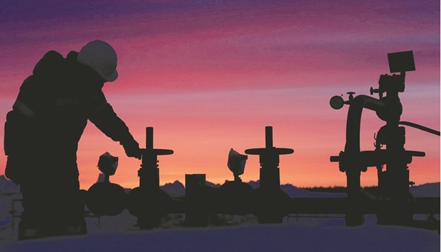 A worker checks the valve of an oil pipe at an oil field owned by Russian state-owned oil producer Bashneft near the village of Nikolo-Berezovka, northwest of Ufa, Bashkortostan, Russia (file). Opec+ yesterday agreed to increase the size of its oil-supply hikes by about 50%, in a deal that kept Russia at the heart of the alliance while also heeding pressure from major consumers including the US.