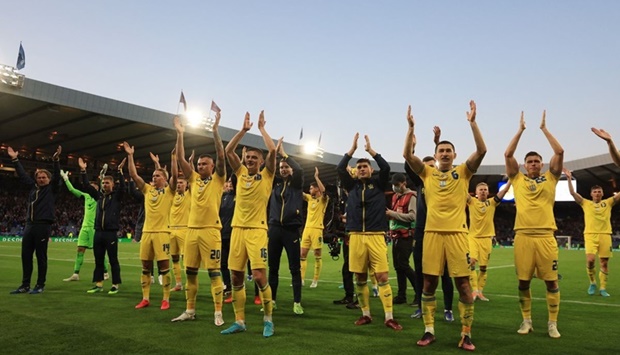 Ukraine celebrate and applaud their fans after the match.