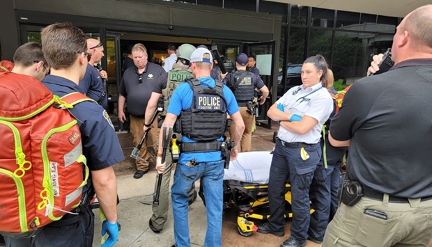 Emergency personnel work at the scene of a shooting at the Warren Clinic in Tulsa, Oklahoma, U.S., June 1, 2022.