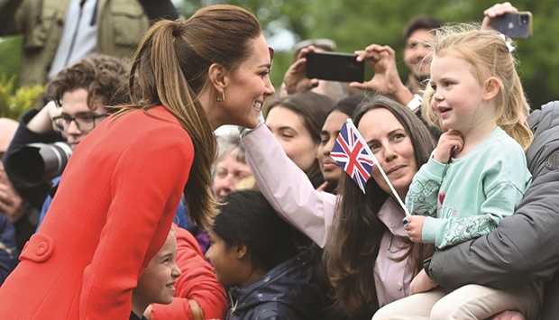 Britainu2019s Catherine, Duchess of Cambridge, speaks to a girl during a visit to Cardiff Castle in Wales yesterday.