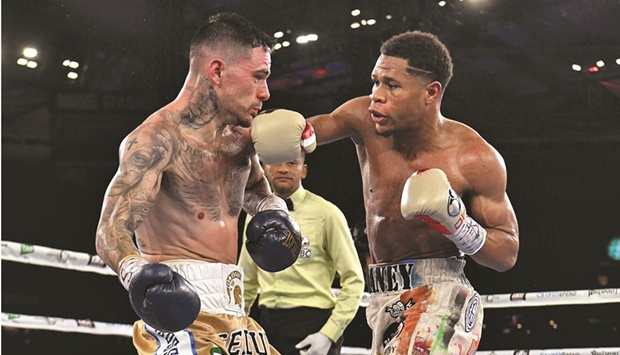 Devin Haney of the US (right) fights with Australiau2019s George Kambosos during their lightweight title bout in Melbourne yesterday.. (AFP)