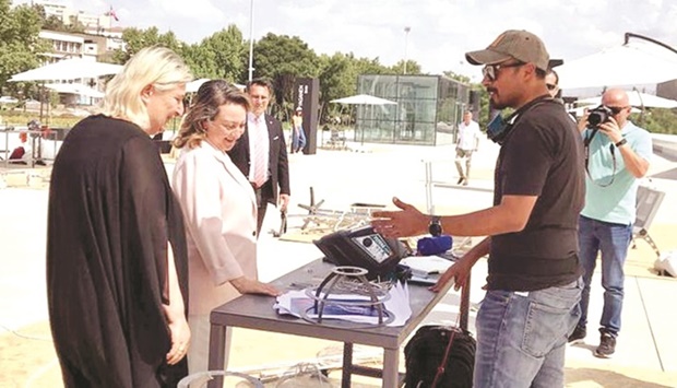 Qatar's Ali Dasmal al-Kuwari presenting his scrap art to visitors.