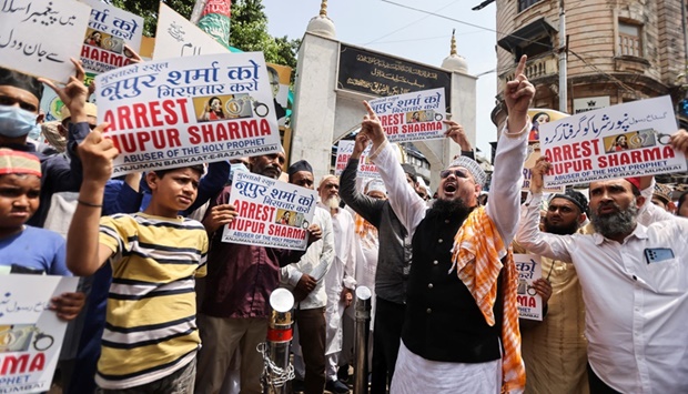 People holding placards shout slogans demanding the arrest of Bharatiya Janata Party (BJP) member Nupur Sharma for her controversial comments, on a street in Mumbai.