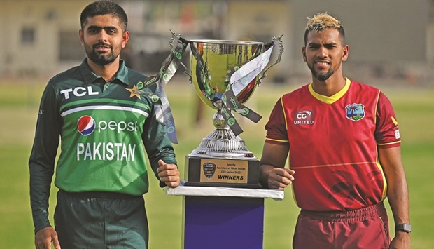 Pakistanu2019s captain Babar Azam (left) and his West Indiesu2019 counterpart Nicholas Pooran pose with the one-day international (ODI) series trophy during a ceremony on the eve of their first match at the Multan Cricket Stadium. (AFP)