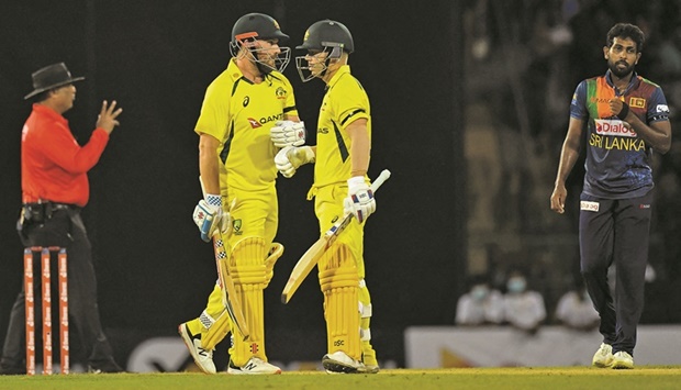 Australiau2019s David Warner (right) listens to his captain Aaron Finch during the first Twenty20 international against Sri Lanka at the R Premadasa International Cricket Stadium in Colombo yesterday. (AFP)