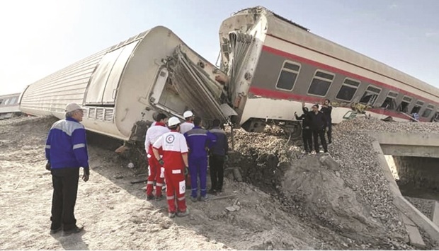 Rescuers work at a train derailment site near Tabas yesterday. (Reuters)