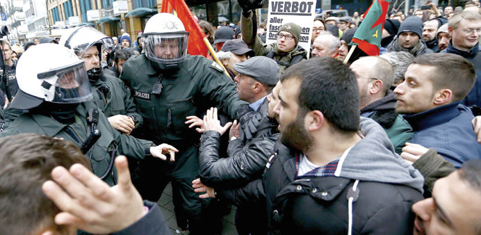 German riot police officers confront protesters during a demonstration against Salafists in Wuppertal. 