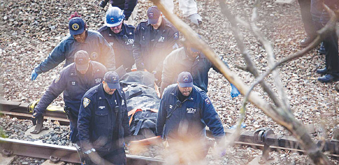 Emergency personnel remove a body after the derailment