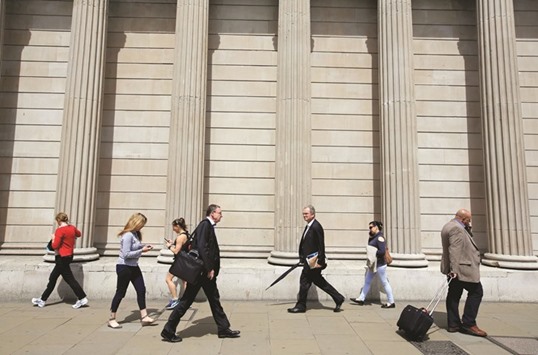 Pedestrians walk past the Bank of England in the City of London. The BoE said yesterday it had seen no clear signs yet of a sharp economic slowdown after last monthu2019s vote to leave the European Union, raising questions over how aggressively it will act to boost the economy when it meets next month.