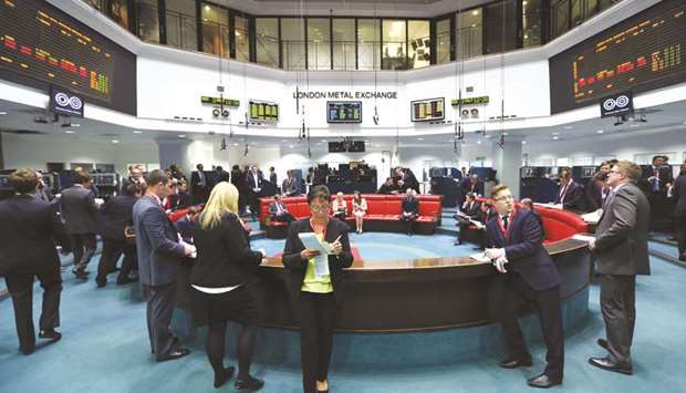 Traders stand outside the open outcry pit following a trading session at the London Metal Exchange. The LME is taking on the most powerful players in the gold market with the launch yesterday of its first futures contract for the commodity since the  middle of the 1980s.