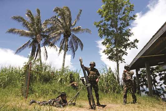 Soldiers launch a mortar from their combat position as government troops continue their assault against insurgents in Marawi city, yesterday.