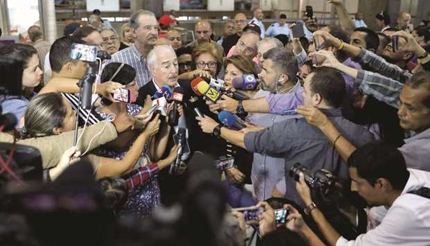 Former president of Colombia Andres Pastrana speaks to journalists next to former president of Mexico Vicente Fox after they arrived at Caracas airport ahead of an unofficial referendum called by the opposition against Venezuelan President Nicolas Madurou2019s government in Venezuela yesterday.