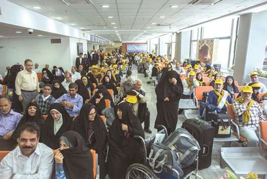 Iranian pilgrims wait at the Imam Khomeini airport in Tehran as they depart for the annual Haj pilgrimage to the holy city of Makkah, yesterday.