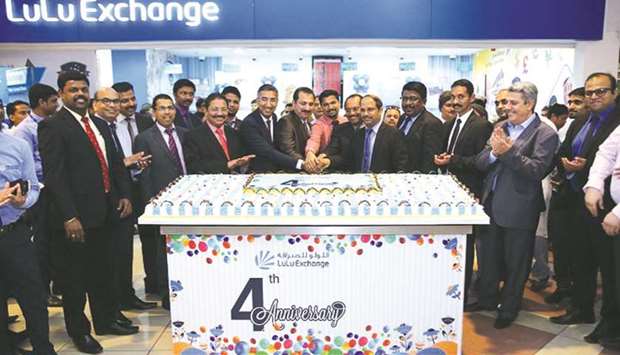 Lulu officials and customers celebrate the fourth anniversary of LuLu Exchange at the companyu2019s D-Ring Road branch.