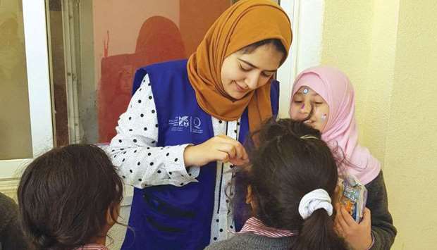 Hamad Bin Khalifa University student Doaa Mohaisen, interacting with refugee children during a service trip to Jordan.