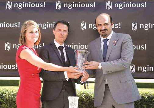 Al Shaqab executive director Khalifa bin Mohamed al-Attiyah receives the owneru2019s trophy after Watan won on Day One of the Qatar Goodwood Festival.