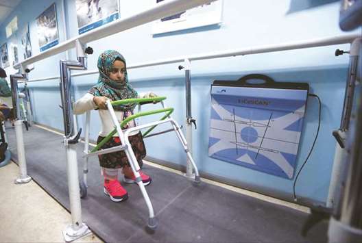 Maya Meri, 8, walks with her new artificial legs at a prosthetic centre in Istanbul, Turkey.