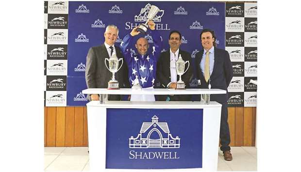 Jockey Olivier Peslier (second from left) lifts his trophy as Al Shahania Stud director Abdul Rahman al-Mansour (second from right) and trainer Julian Smart look on after His Highness Sheikh Mohamed bin Khalifa al-Thaniu2019s Gazwan won the Shadwell Dubai International Stakes (Group 1 PA)