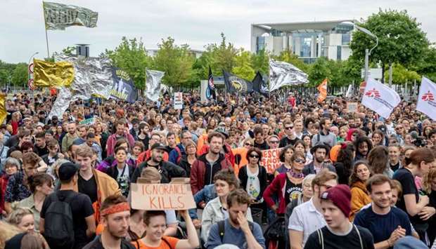 Supporters of the NGO Sea-Watch hold flags and rescue blankets during a demonstration in solidarity with the German captain of rescue vessel Sea-Watch 3, Carola Rackete outside the Chancellery in Berlin