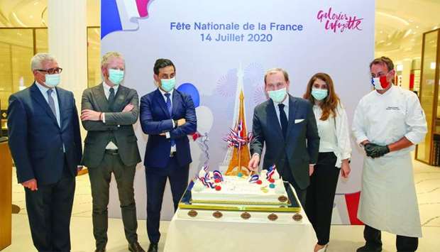 Ambassador Franck Gellet cutting the ceremonial cake, in the presence of Galeries Lafayette Doha and ABA Holding officials, to mark the occasion