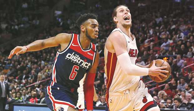 The Miami Heatu2019s Kelly Olynyk (right) drives against the Washington Wizards in the second quarter at the AmericanAirlines Arena in Miami on January 22, 2020. (TNS)