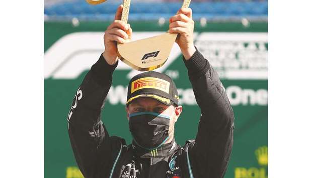 Mercedesu2019 Finnish driver Valtteri Bottas celebrates with the trophy on the podium after winning the Austrian Formula One Grand Prix yesterday in Spielberg, Austria.