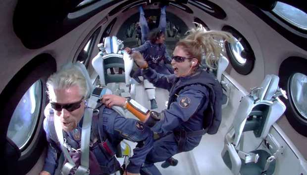 Billionaire Richard Branson makes a statement as crew members Beth Moses and Sirisha Bandla float in zero gravity on board Virgin Galactic's passenger rocket plane VSS Unity after reaching the edge of space above Spaceport America near Truth or Consequences