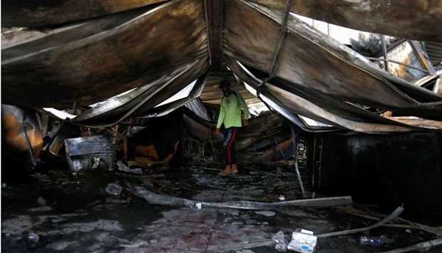 A man inspects the damage at al-Hussain coronavirus hospital where a fire broke out, in Nassiriya, Iraq. REUTERS