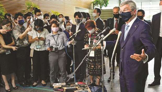 International Olympic Committee President Thomas Bach (right) speaks to the media after meeting Japanese Prime Minister Yoshihide Suga at the prime ministeru2019s official residence in Tokyo yesterday. (AFP)