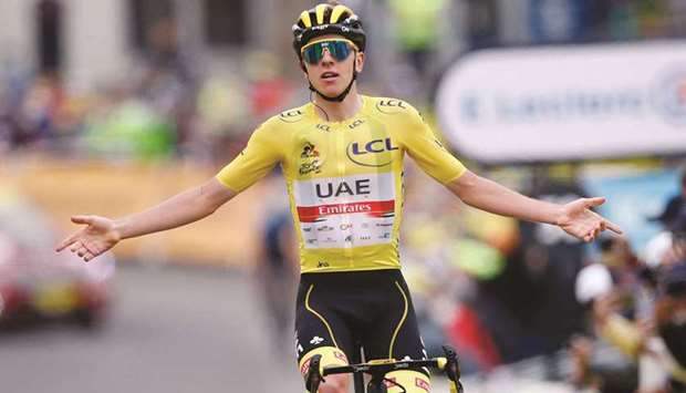 Tadej Pogacar of Slovenia wearing the yellow jersey celebrates after winning Stage 18 of the Tour de France yesterday. (Reuters)