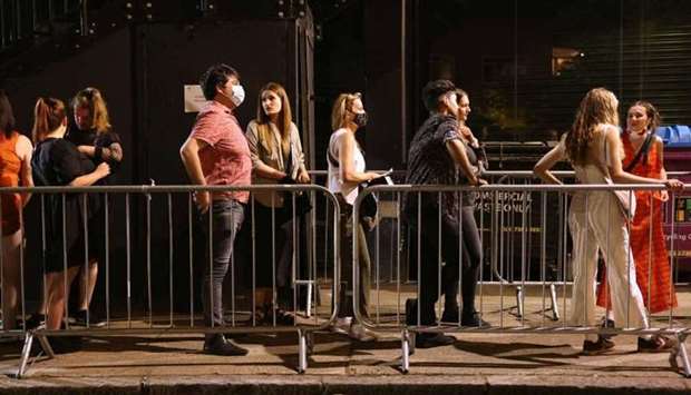 People arrive for the ,00:01, event organised by Egyptian Elbows at Oval Space nightclub, as England lifted most coronavirus disease restrictions at midnight, in London