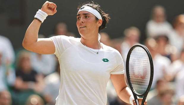 Tunisiau2019s Ons Jabeur celebrates a point against Spainu2019s Garbine Muguruza during their womenu2019s singles third round match at Wimbledon yesterday.