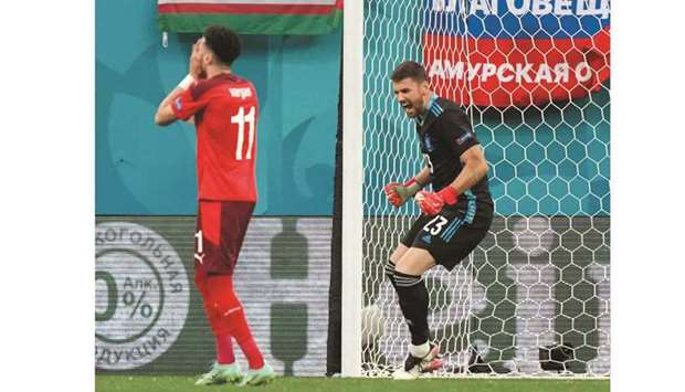 Spainu2019s goalkeeper Unai Simon (R) celebrates as Switzerlandu2019s midfielder Ruben Vargas (L) reacts after missing a penalty kick during their Euro 2020 quarter-final in Saint Petersburg yesterday.