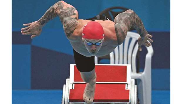 Britainu2019s Adam Peaty competes in the heats of the menu2019s 100m breaststroke at the Tokyo Aquatics Centre yesterday. (AFP)