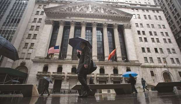 Pedestrians walking past the New York Stock Exchange. Expectations that Treasury yields may stay tame in the second half of the year are pushing some investors to take a second look at companies whose dividend payouts beat those offered on US government bonds.