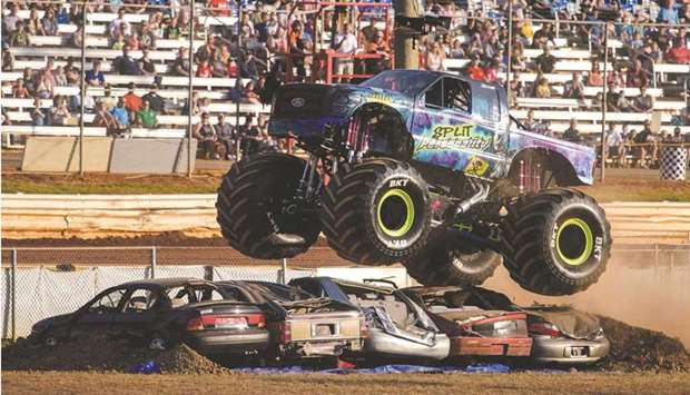 Spectators watch as monster trucks perform stunts at the u2018Monster Freedom Festu2019, during Independence Day weekend celebrations at the Lincoln Speedway in Abbottstown, Pennsylvania.