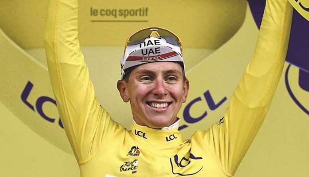 Team UAE Emiratesu2019 Tadej Pogacar of Slovenia celebrates his overall leader yellow jersey on the podium at the end of the 9th stage of the 108th edition of the Tour de France cycling race, 144.9km between Cluses and Tignes, yesterday. (AFP)