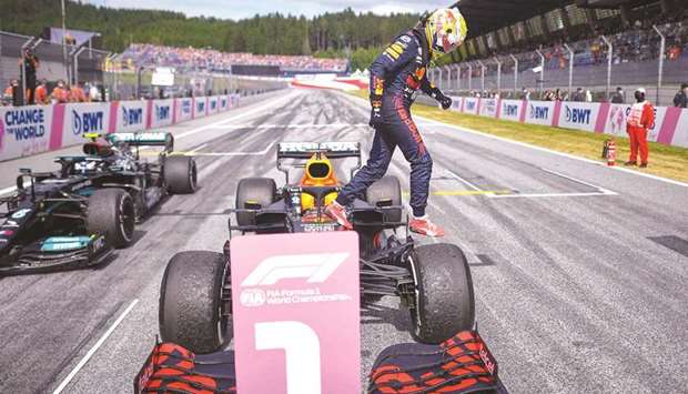 Red Bullu2019s Dutch driver Max Verstappen (also inset) gets out of his car after winning the Formula One Austrian Grand Prix at the Red Bull Ring race track in Spielberg, Austria.