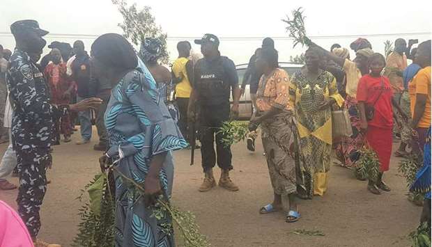 Parents of abducted students stand on Kachia Road that leads to Bethel Baptist School after the kidnapping in Kaduna yesterday.