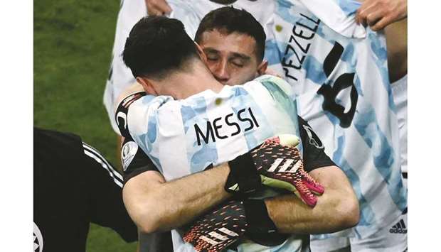 Argentinau2019s goalkeeper Emiliano Martinez celebrates with captain Lionel Messi after his penalty shoot heroics against Colombia in the semi-final of the Copa America at the Mane Garrincha Stadium in Brasilia, Brazil, on Tuesday night. (AFP)