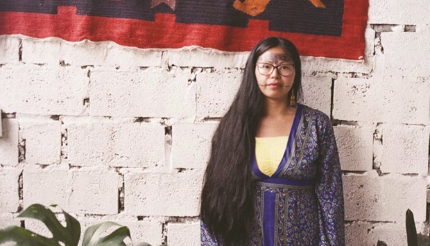 Itaya Andy, an Indigenous healer from the Sarayaku community, stands in the Casa de Mujeres Amaz?nicas in Puyo, Ecuador.