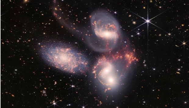 Stephanu2019s Quintet captured by the James Webb Space Telescope (JWST), a visual grouping of five galaxies, in a new light. AFP/NASA