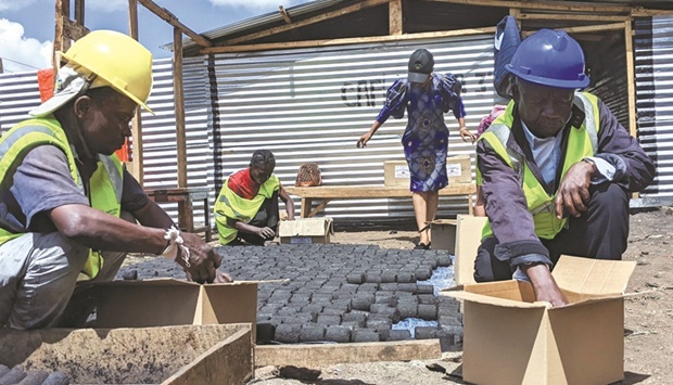 Bavon Mubake a member of the rehabilitation centre for the elderly and a technician of the Carrefour de Facilitation pour les indigents (CAFI) and Sylvestere Bin Kyuma arrange eco-friendly cooking charcoal in Bukavu, South Kivu in the east of the Democratic Republic of Congo.