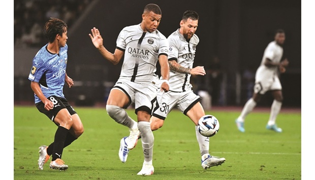 Paris Saint-Germainu2019s Lionel Messi (right) controls the ball next to teammate Kylian Mbappe during a friendly match against Kawasaki Frontale at the National Stadium in Tokyo yesterday. (AFP)