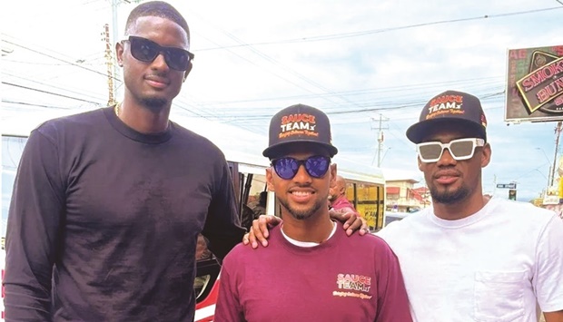 West Indies captain Nicholas Pooran (centre) is seen with former skipper Jason Holder (left) prior to his teamu2019s first One Day International against India at Queenu2019s Park Oval, Port of Spain, Trinidad, today.