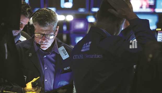 Traders work on the floor of the New York Stock Exchange. The US currency stands near a 20-year high against a basket of its peers and is up 15.1% in the past year, lifted by a hawkish Federal Reserve and investors seeking shelter from turbulent markets.